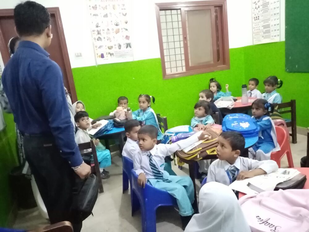 Sora Chan with young students in a Pakistani classroom