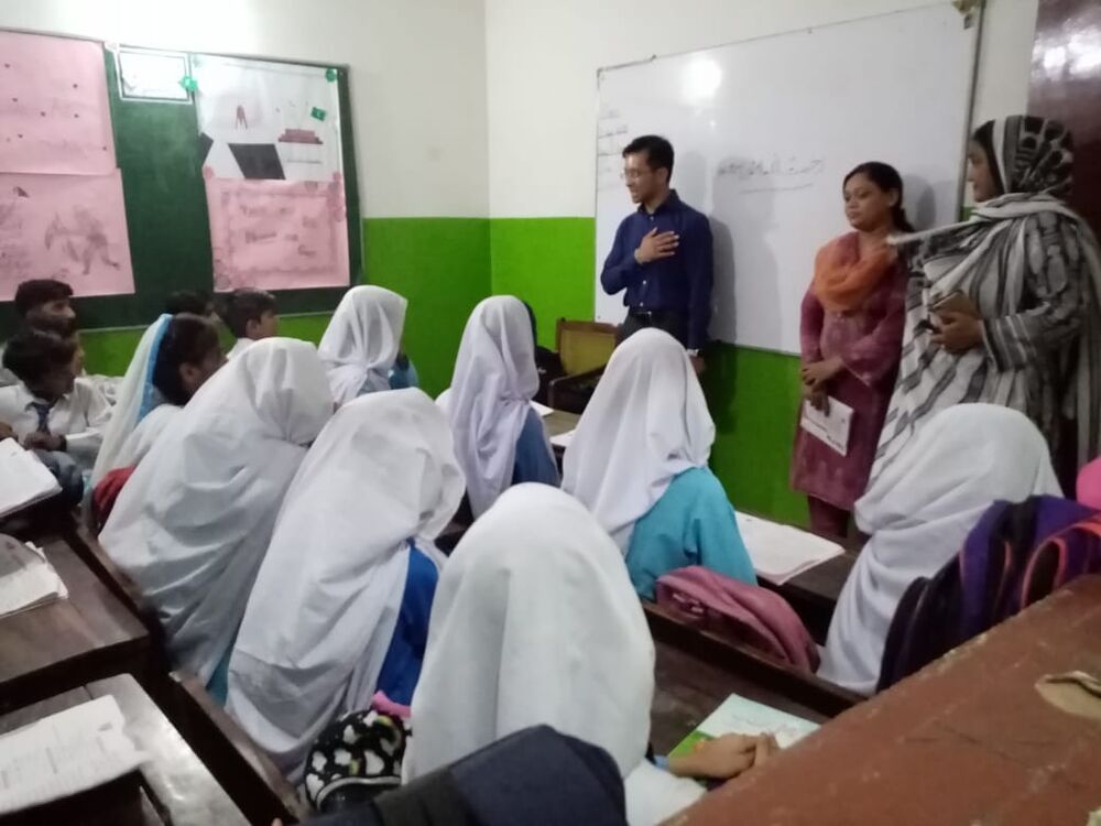 Sora speaking to students in a classroom